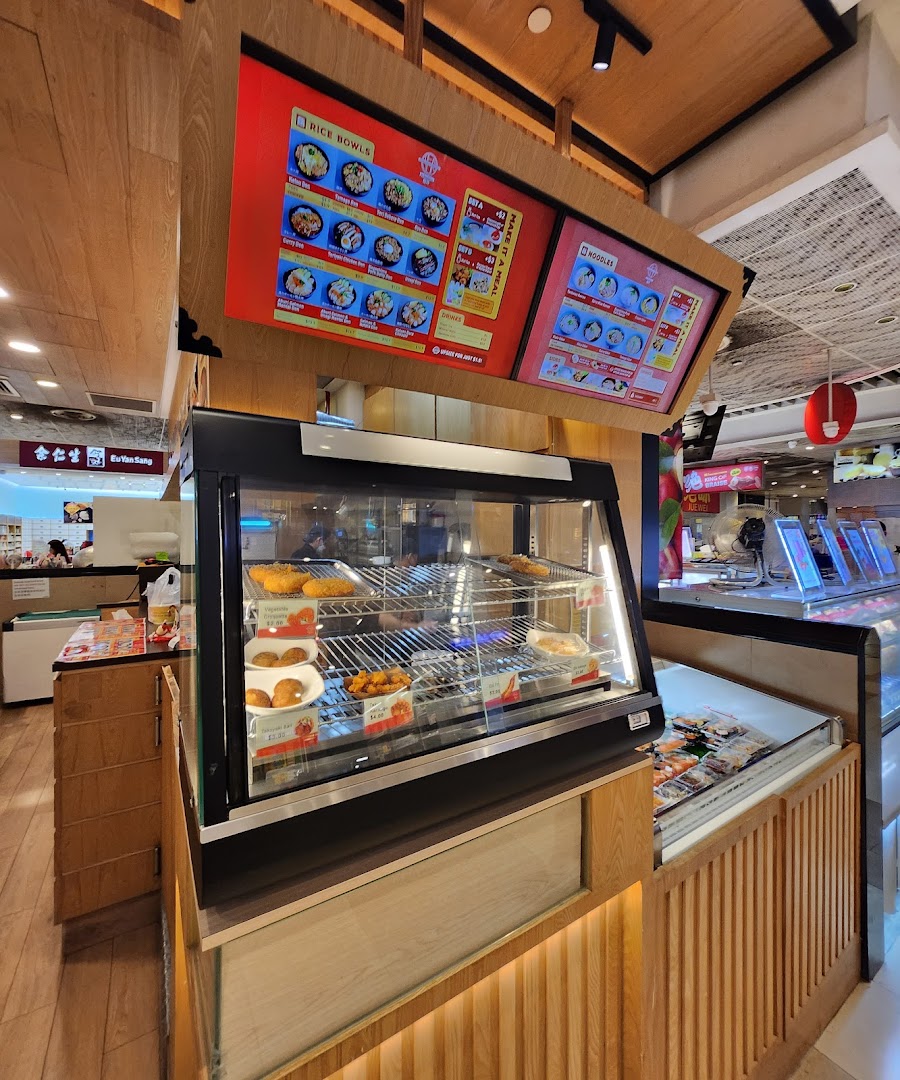 Interior view of a food shop with display cases and digital menus.