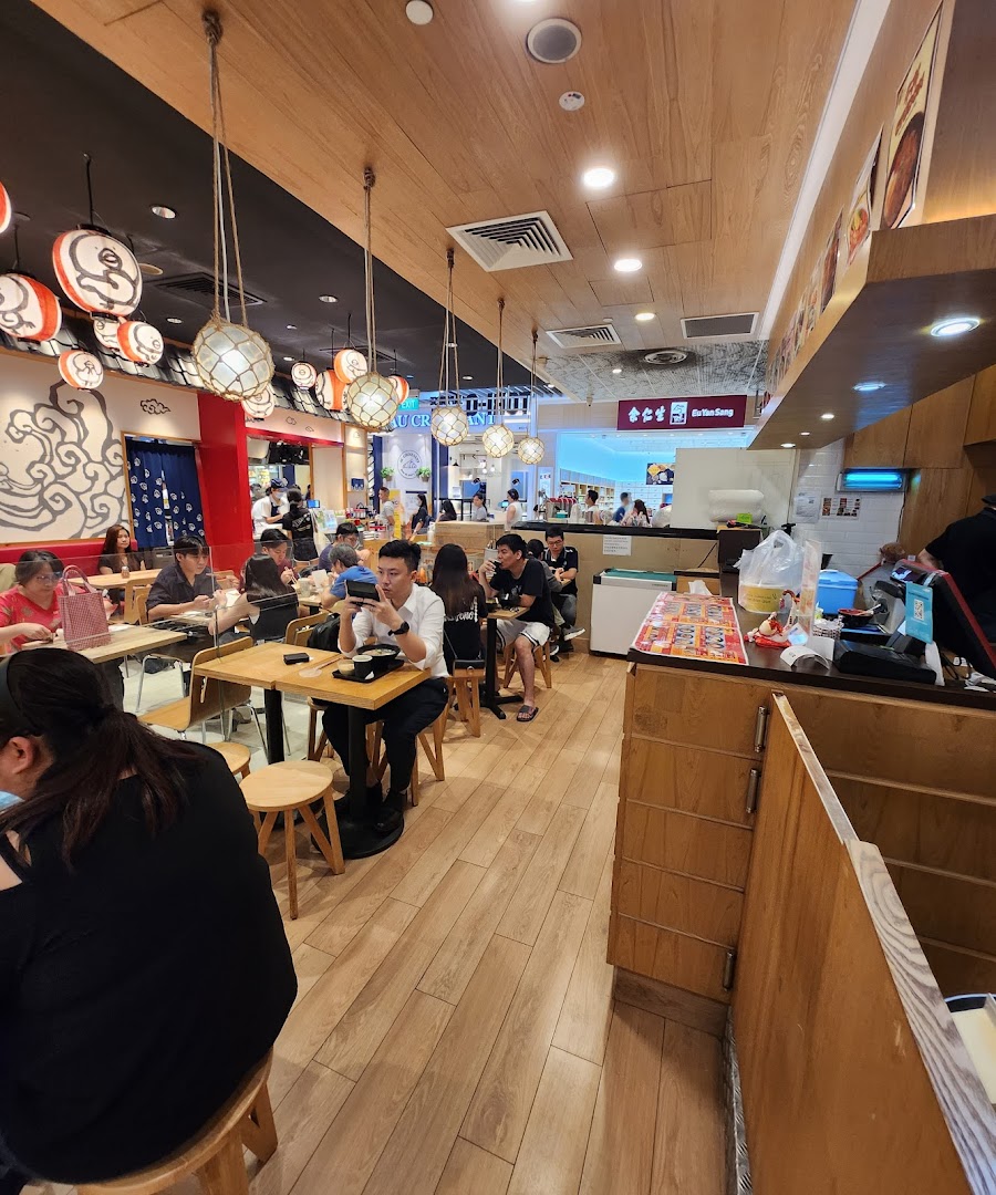 Interior view of a busy restaurant with customers dining at tables.