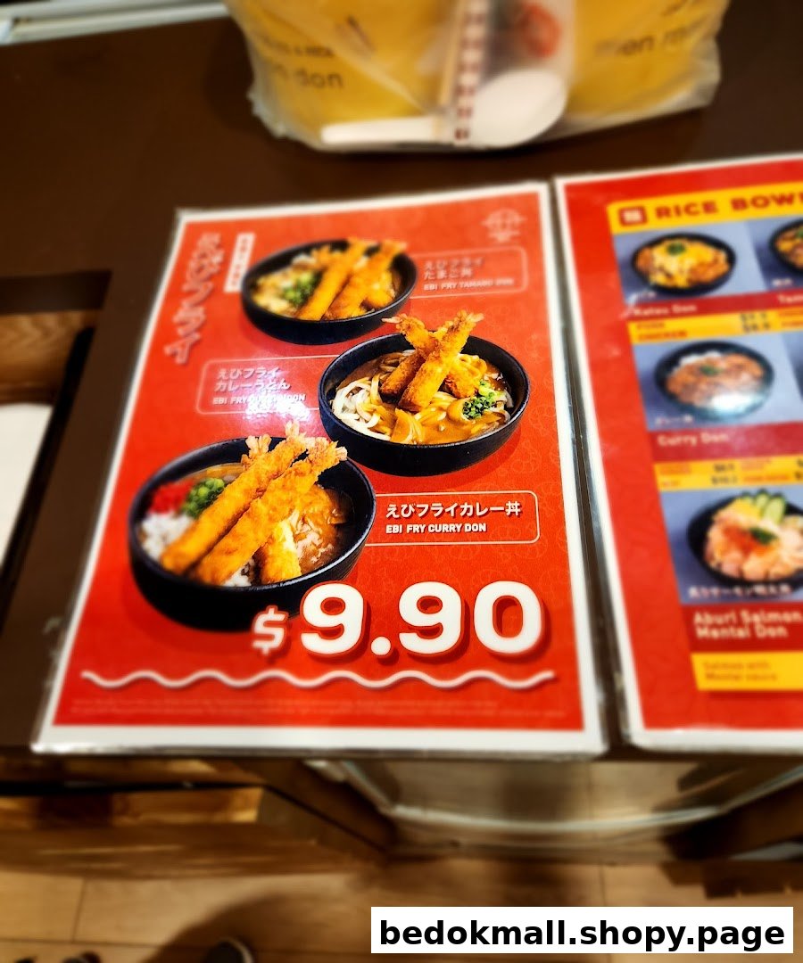 Close-up of a food menu displaying various rice and noodle dishes with prices.