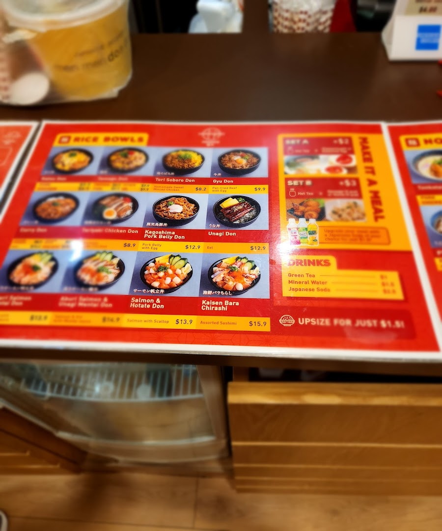 Menu board showing rice bowls, sets, drinks, and prices.