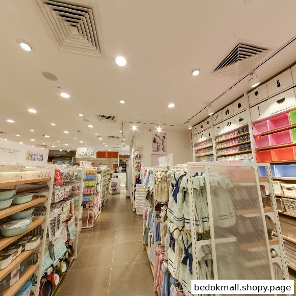 Interior view of a retail shop with aisles and products on display.