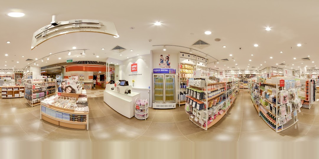Interior view of a MINISO store with products on shelves and a checkout counter.