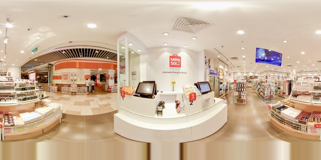 Interior view of a MINISO store with checkout counter and product displays.