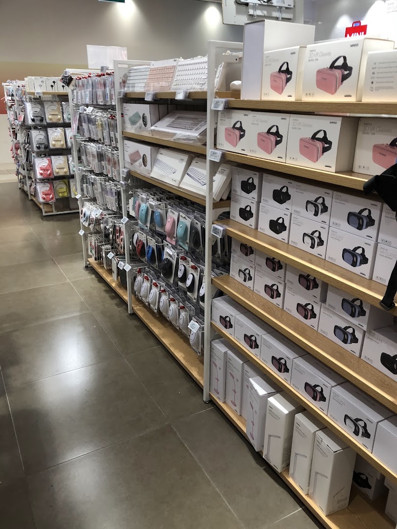 Interior view of a retail shop with shelves full of electronic products and accessories.