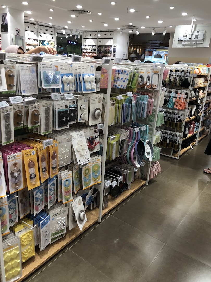 Interior view of a MINISO store with shelves full of various products.
