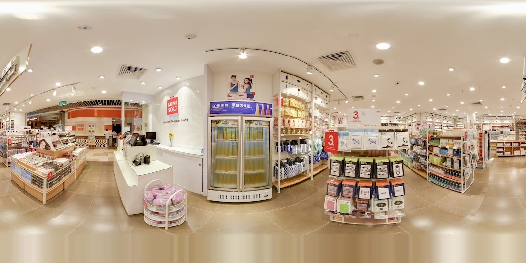 Panoramic interior view of a MINISO store showing products and checkout area.