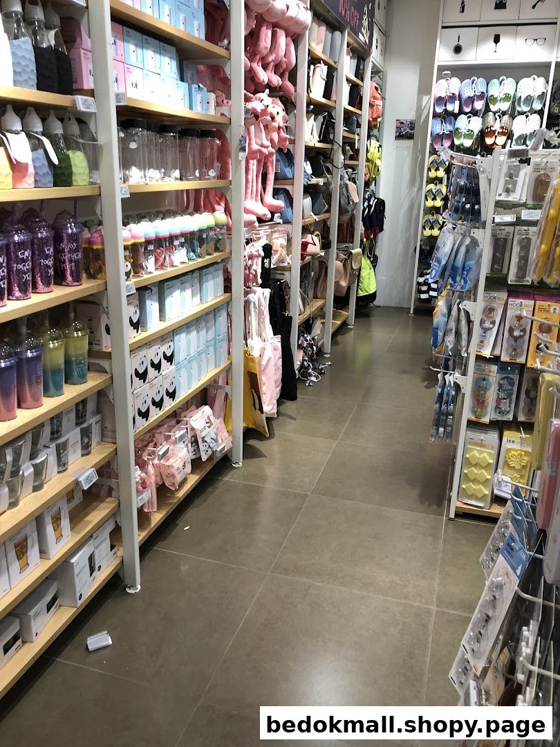 Interior view of a retail store aisle with shelves full of various products.