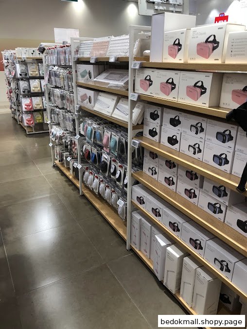 Interior view of a retail shop with aisles displaying electronics and accessories.