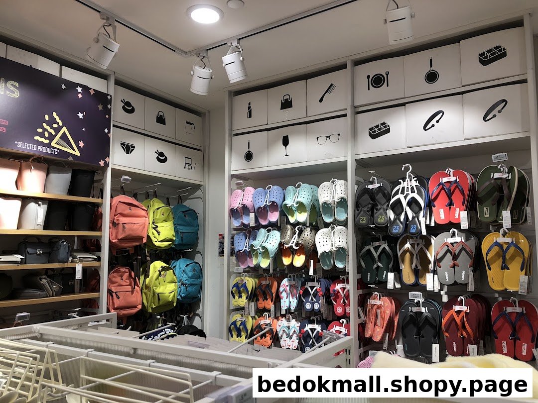 Interior view of a retail shop displaying bags, backpacks, and footwear.