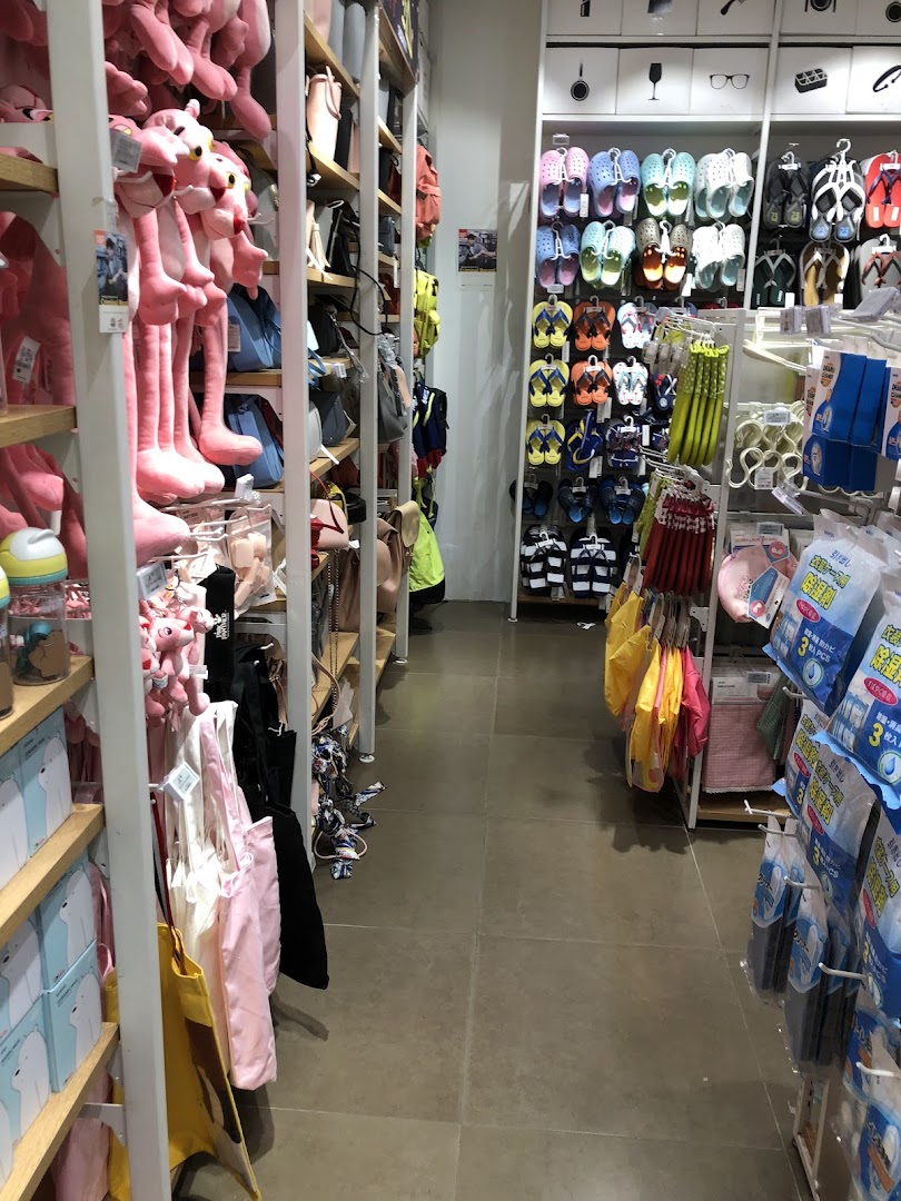 Interior view of a retail shop with shelves displaying plush toys, bags, and footwear.