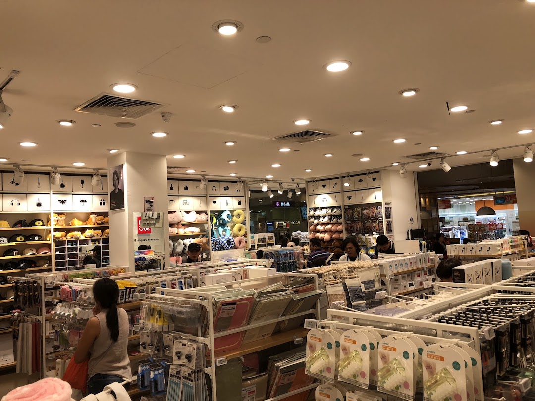 Interior view of a retail shop with products on shelves and customers browsing.
