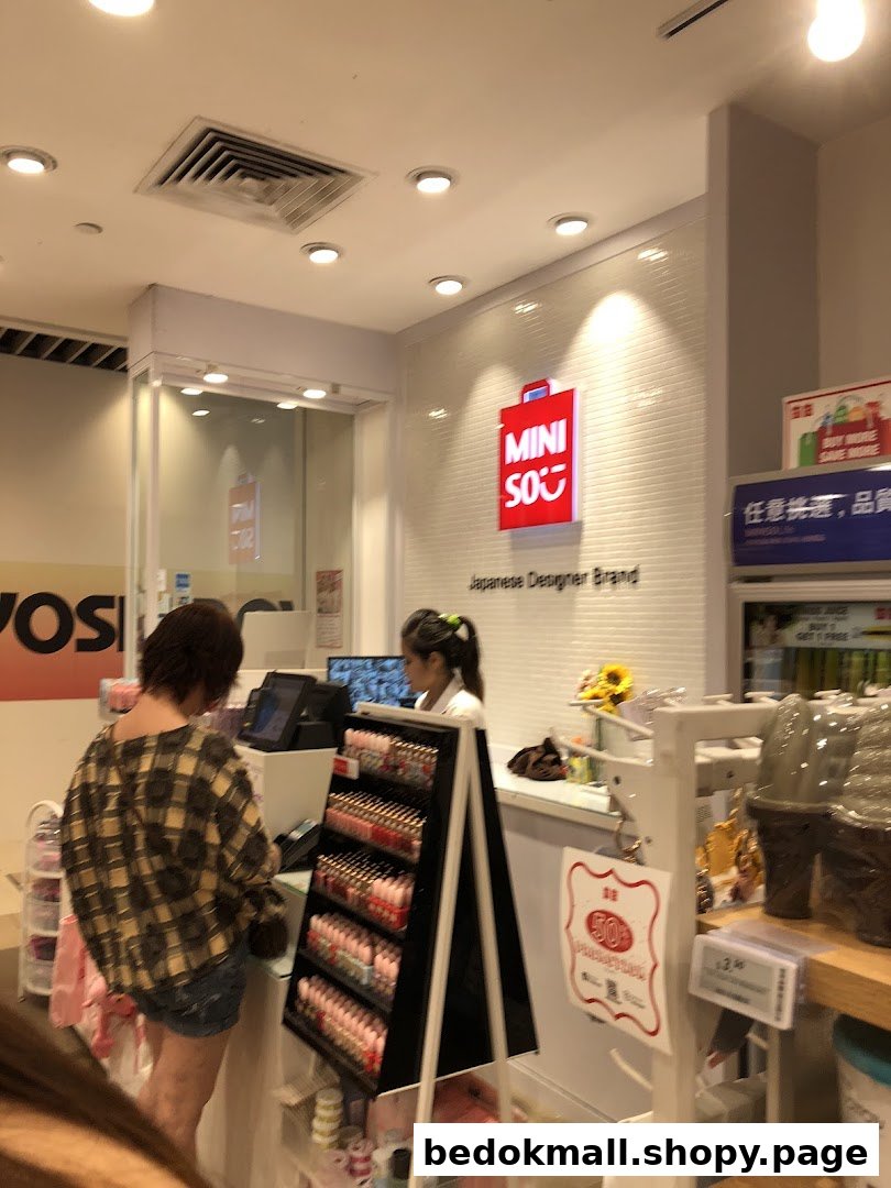 Customer at checkout counter inside a MINISO store with staff and products.