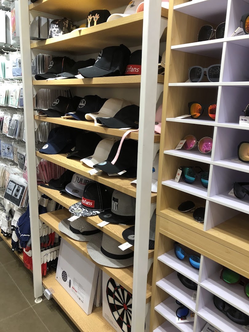 Shelves filled with hats, sunglasses, and other merchandise in a retail store.