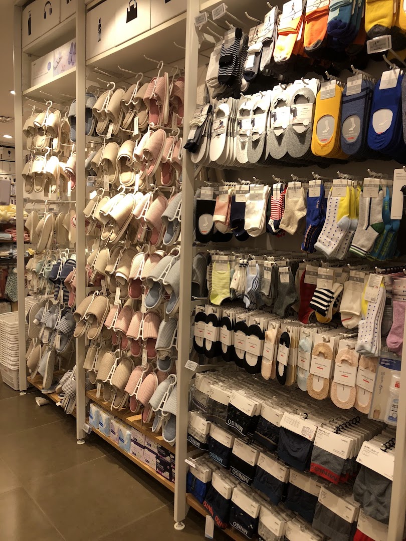 Interior view of a retail shop displaying slippers and socks on shelves.