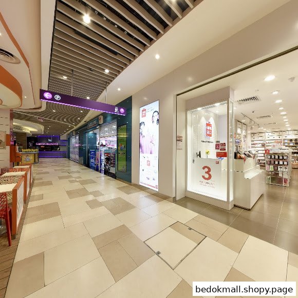 MINISO shop entrance and display window in a brightly lit mall.