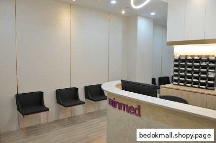 Clinic reception area with a branded desk and waiting chairs.