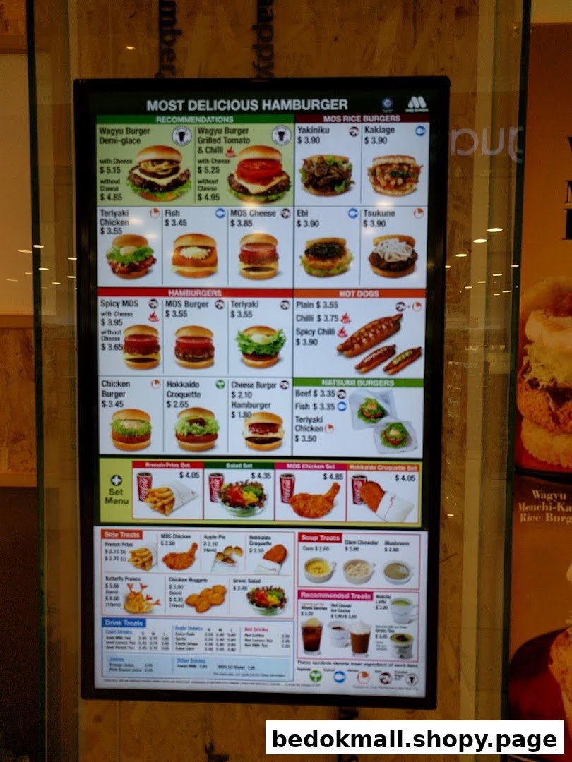 A digital menu board displaying various burgers, sides, and drinks.