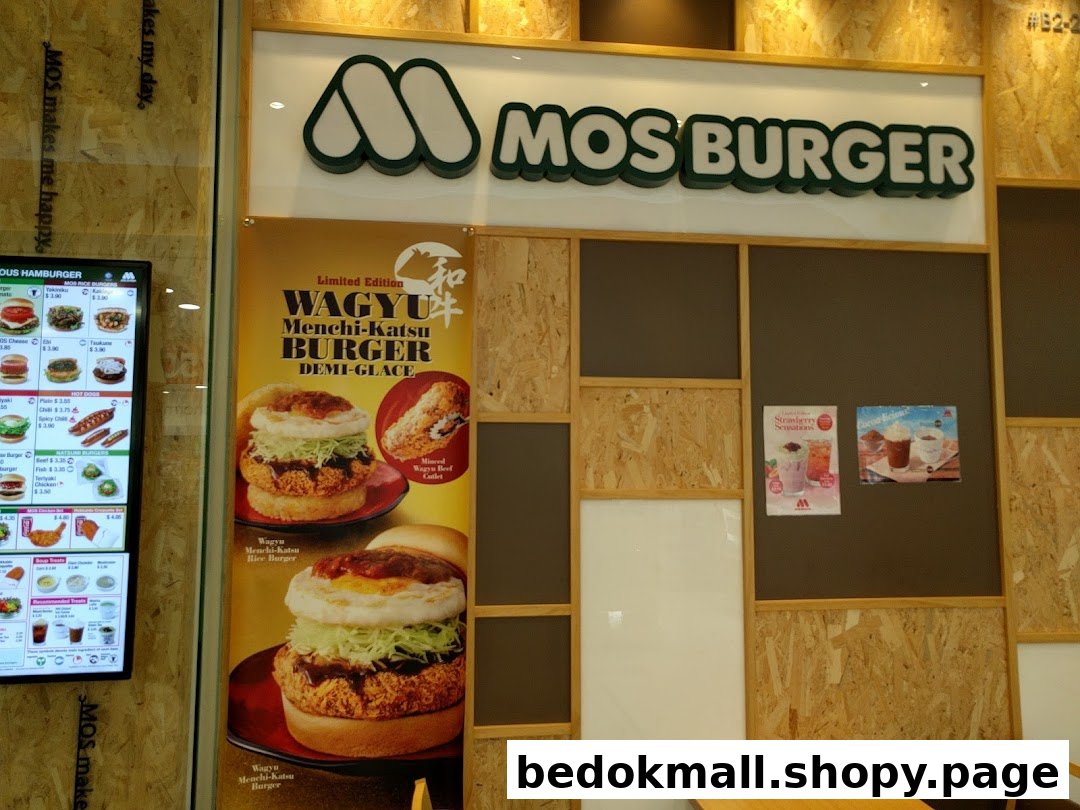 Interior view of MOS Burger with branding, promotional poster, and digital menu.