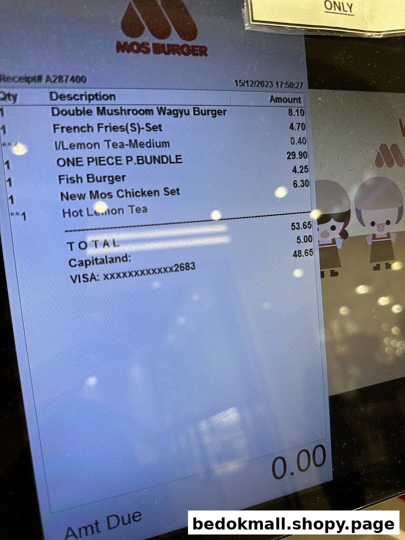 Digital screen displaying a Mos Burger order receipt with items and total.