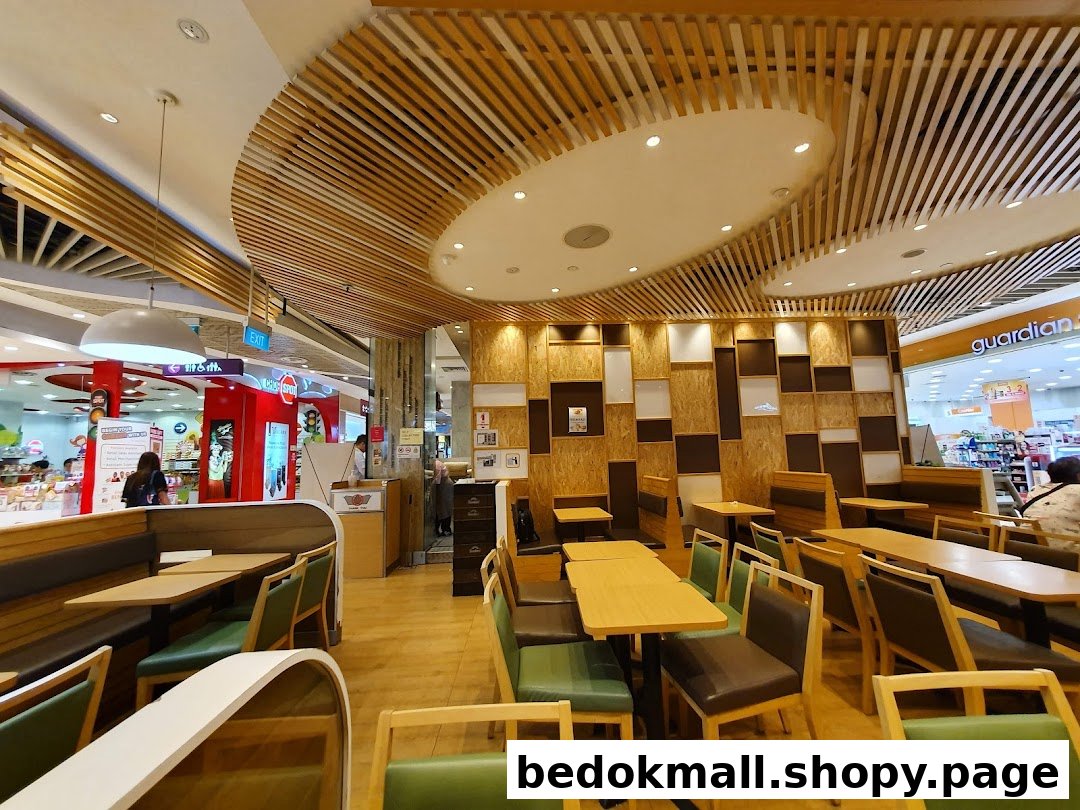 Interior view of a restaurant with tables, chairs, and booths.