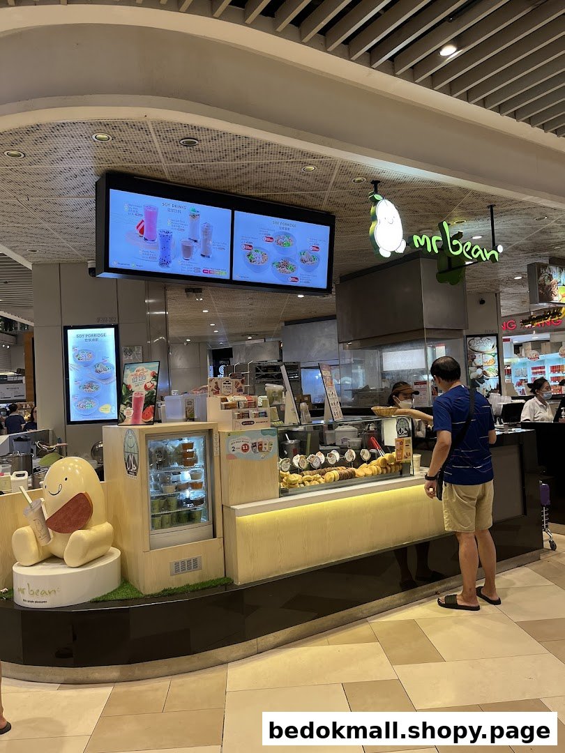 Interior view of a Mr Bean shop counter with customers and products.