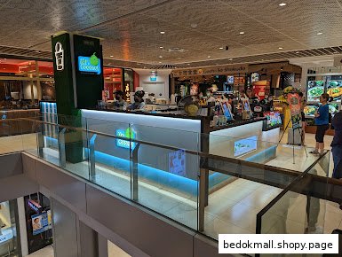 An interior view of a Mr. Coconut kiosk inside a mall, seen from an upper level.