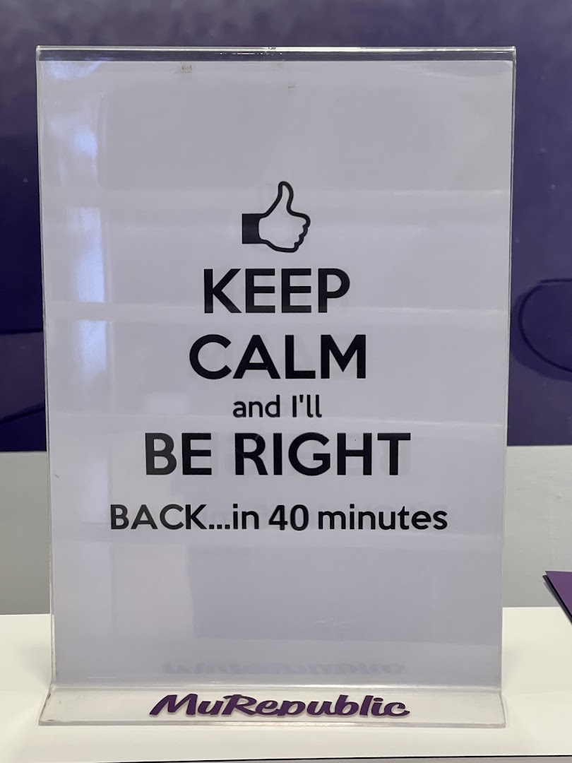 A humorous 'Keep Calm' sign in an acrylic holder with MyRepublic logo.