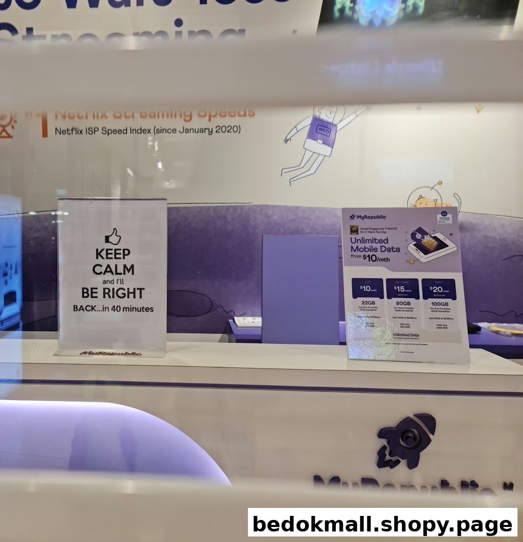 Shop counter displaying mobile data plans and a 'be right back' sign.