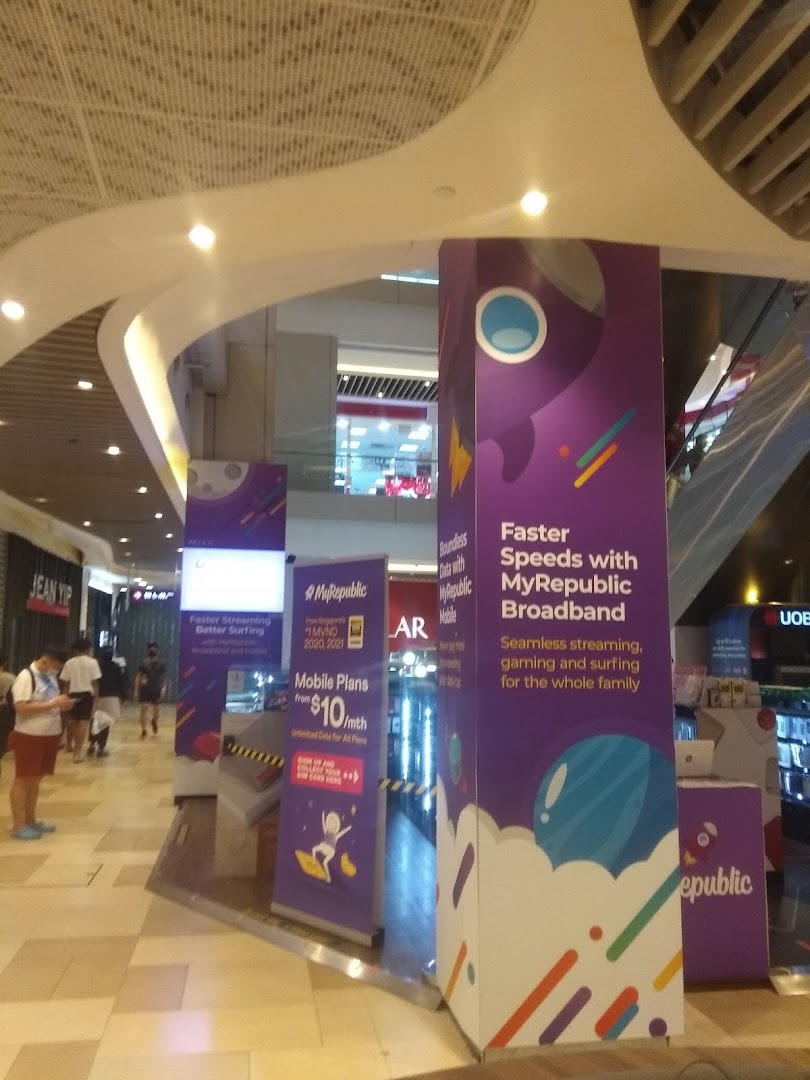 Large MyRepublic promotional pillars and people in a mall interior.