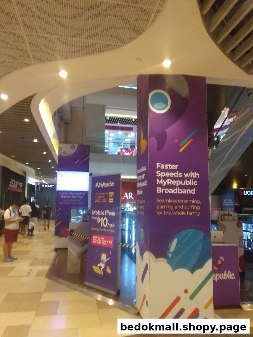 Large MyRepublic promotional pillars and people in a mall interior.