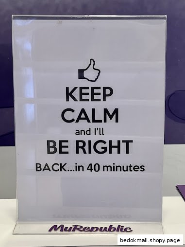 A sign in an acrylic holder says 'Keep Calm...Back in 40 minutes'.
