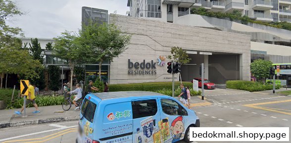 Exterior view of Bedok Residences building with street, people, and a blue van.