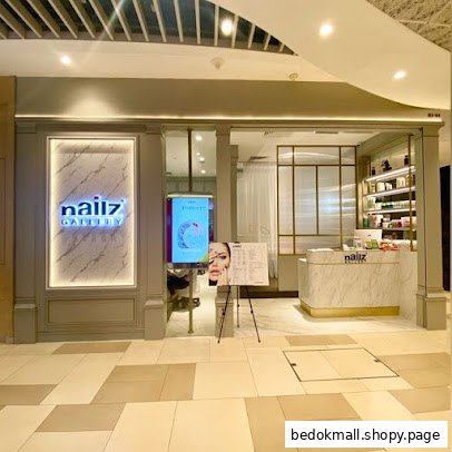 Exterior view of a nail salon with signage and reception desk visible.