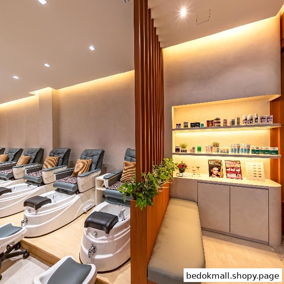 Interior of a nail salon with pedicure chairs and product display shelves.