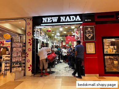 Entrance of a barber shop with customers inside.