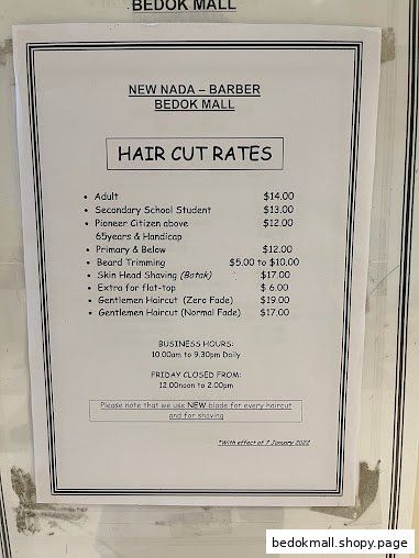 A sign displaying haircut rates and business hours for a barber shop.