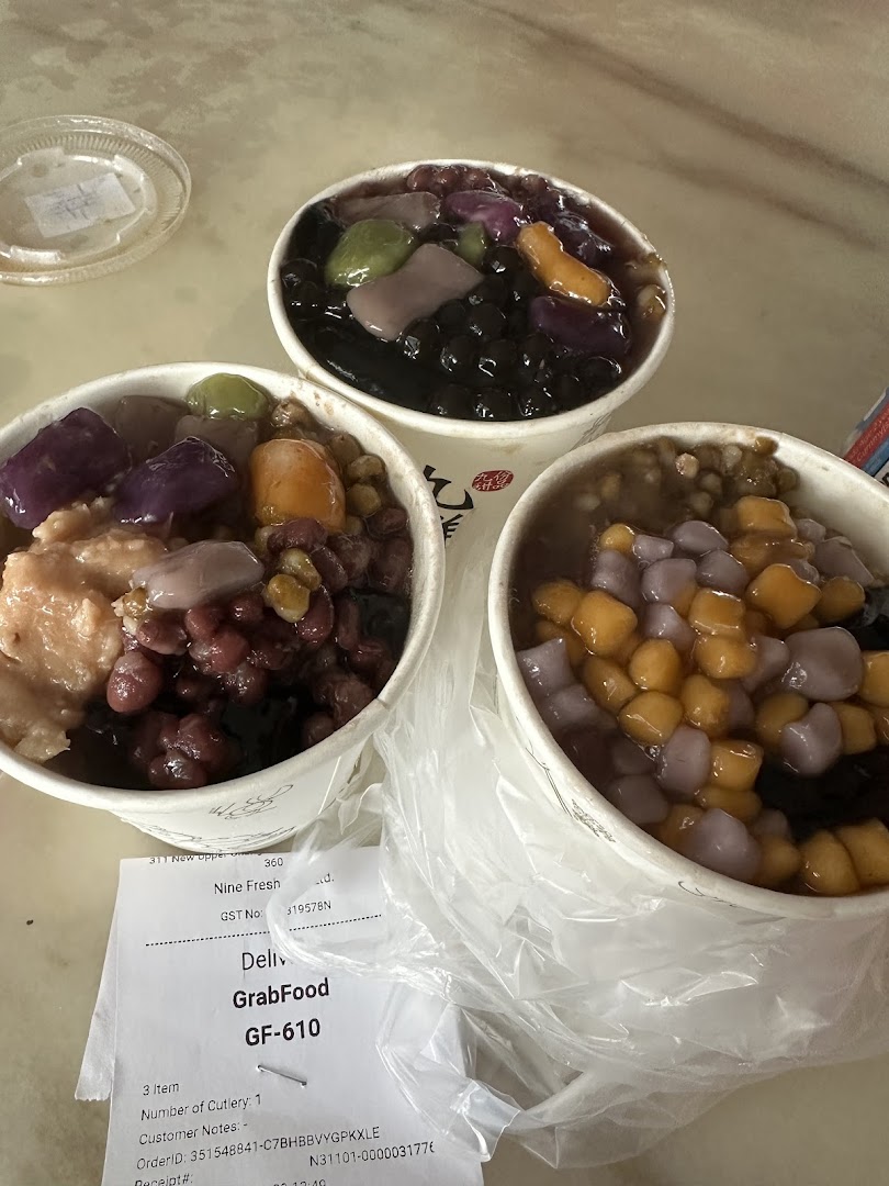 Three bowls of colorful desserts and a delivery receipt on a table.