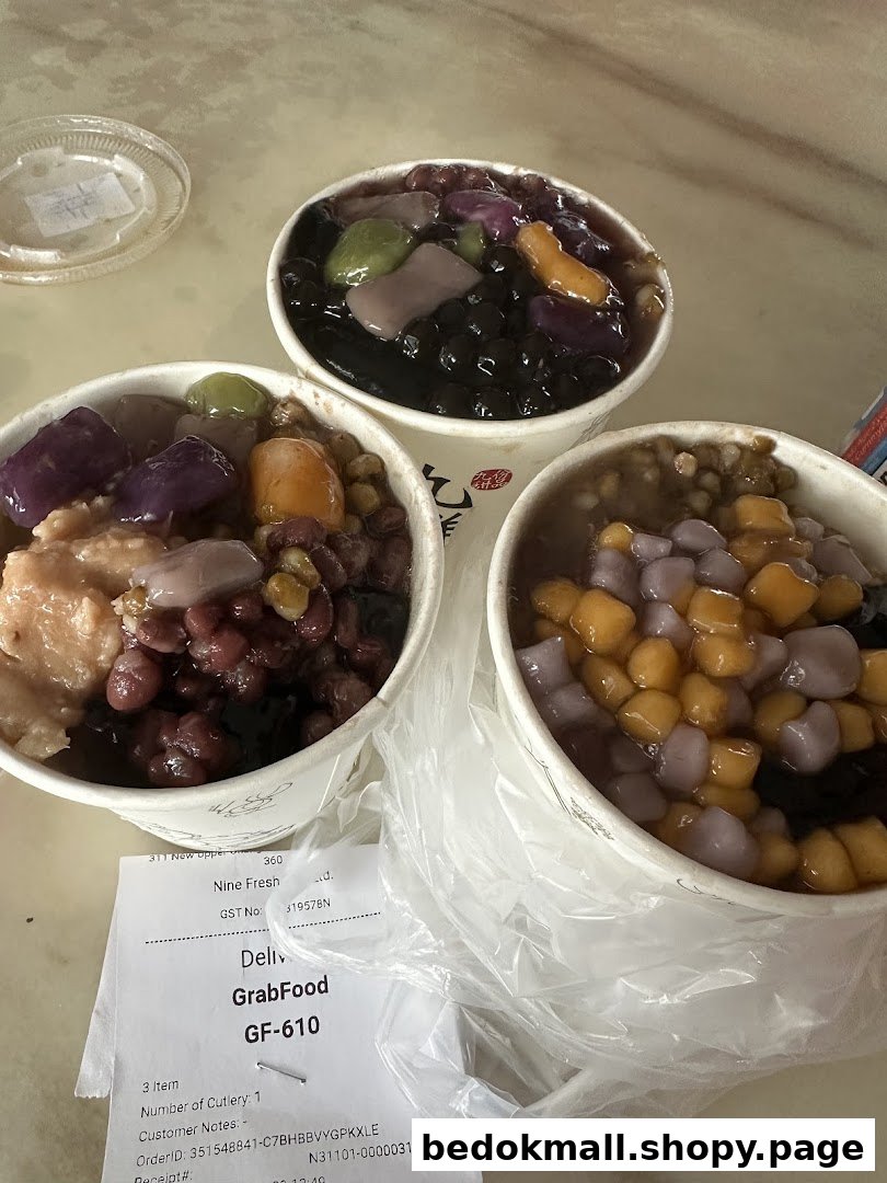 Three bowls of colorful desserts and a delivery receipt on a table.