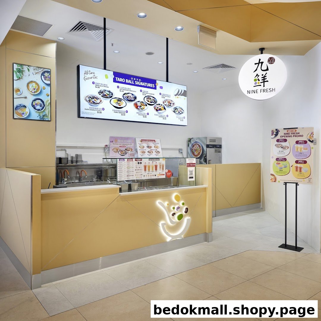 Dessert shop interior showing counter, digital menu, and promotional signs.