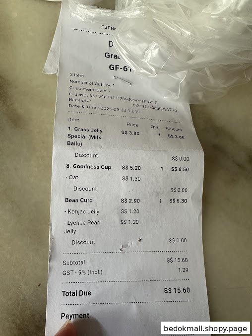 Close-up of a paper receipt detailing dessert items and total cost.