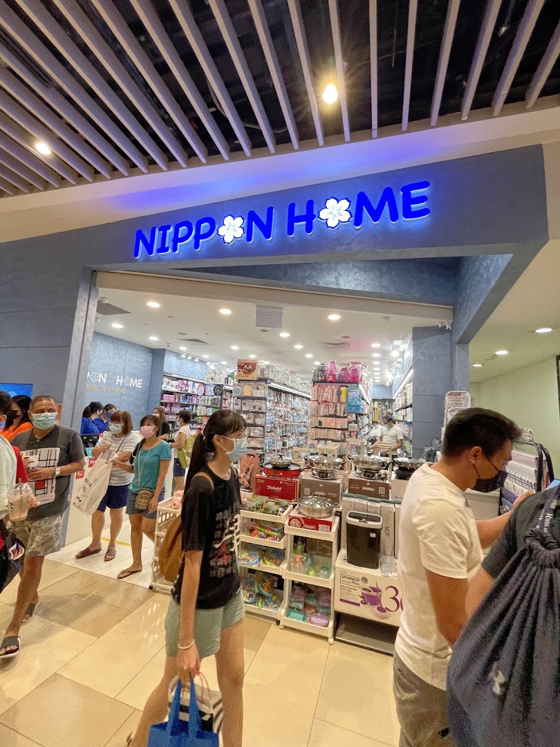 Entrance of Nippon Home with customers and visible interior.