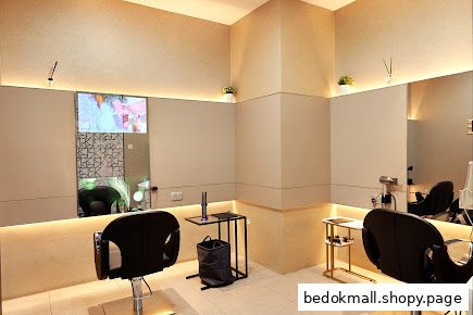 Interior of a modern hair salon with styling chairs and mirrors.