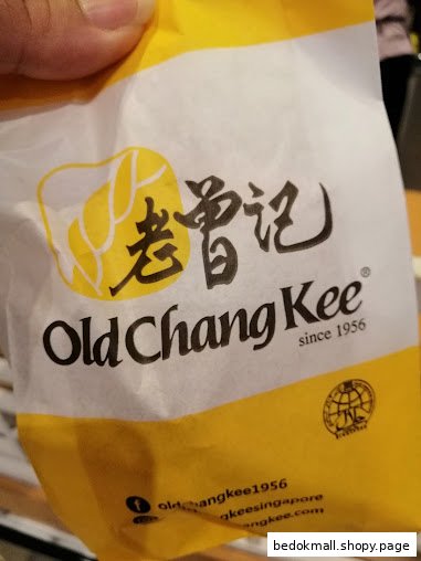 Close-up of an Old Chang Kee branded paper bag.