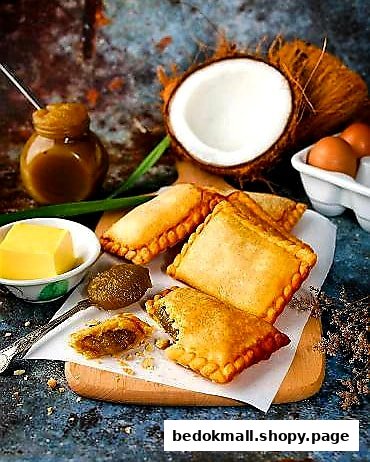 Fried pastries with coconut, eggs, and other ingredients on a wooden board.
