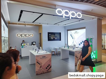 Interior view of an OPPO concept store with product displays and customers.
