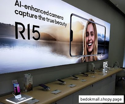 Interior view of a phone shop with a display counter and large advertisement.