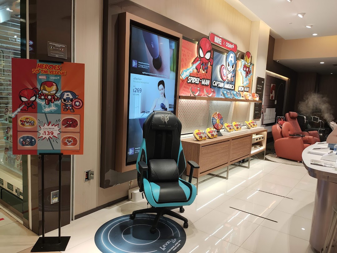 Interior view of a retail shop displaying chairs, a large screen, and Marvel promotions.