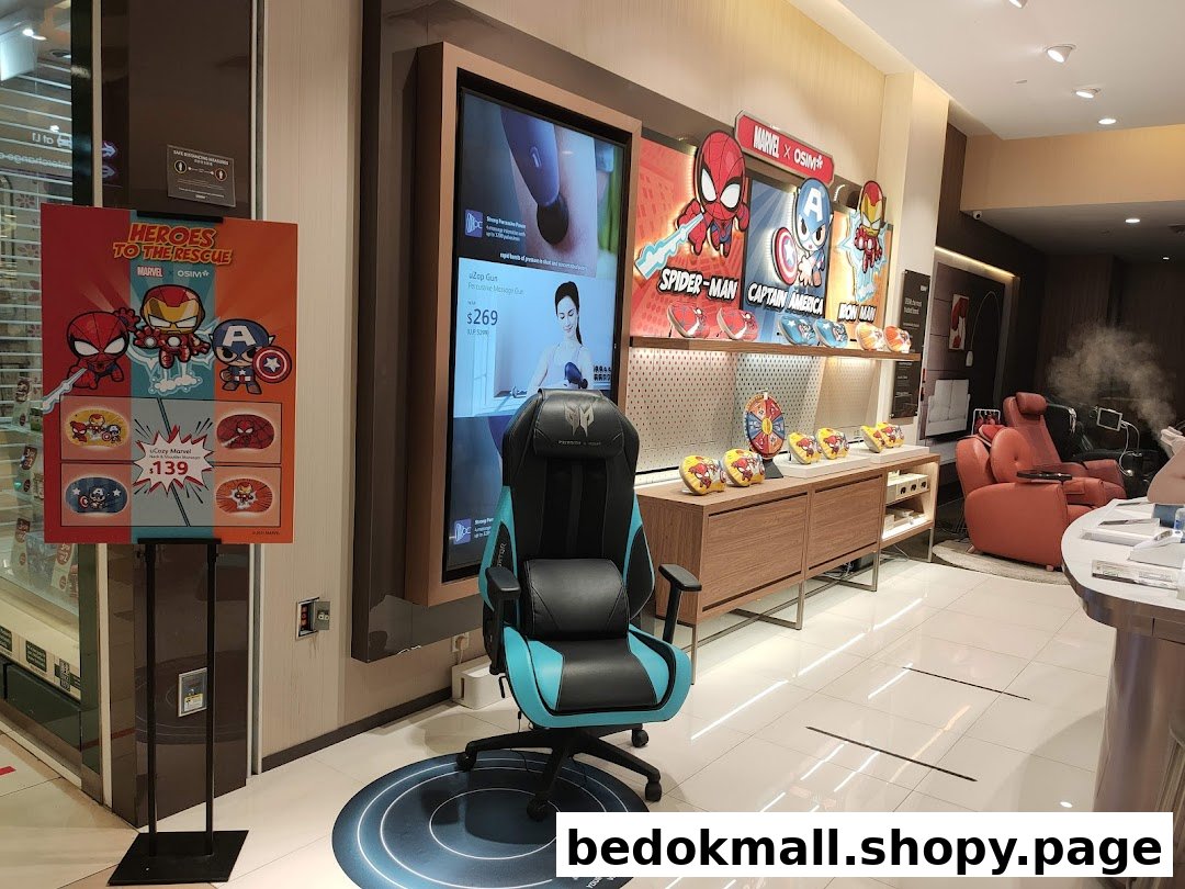 Interior view of a retail shop displaying chairs, a large screen, and Marvel promotions.