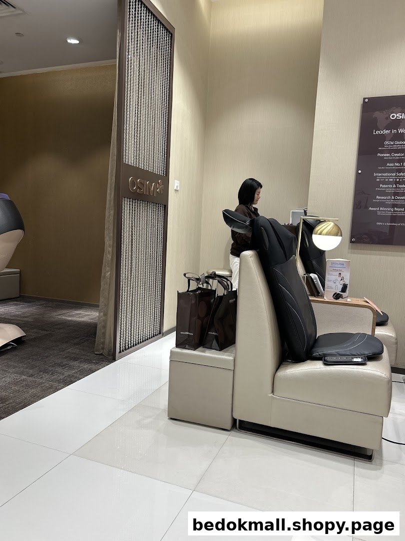 Interior view of OSIM shop with a person on a product display chair.