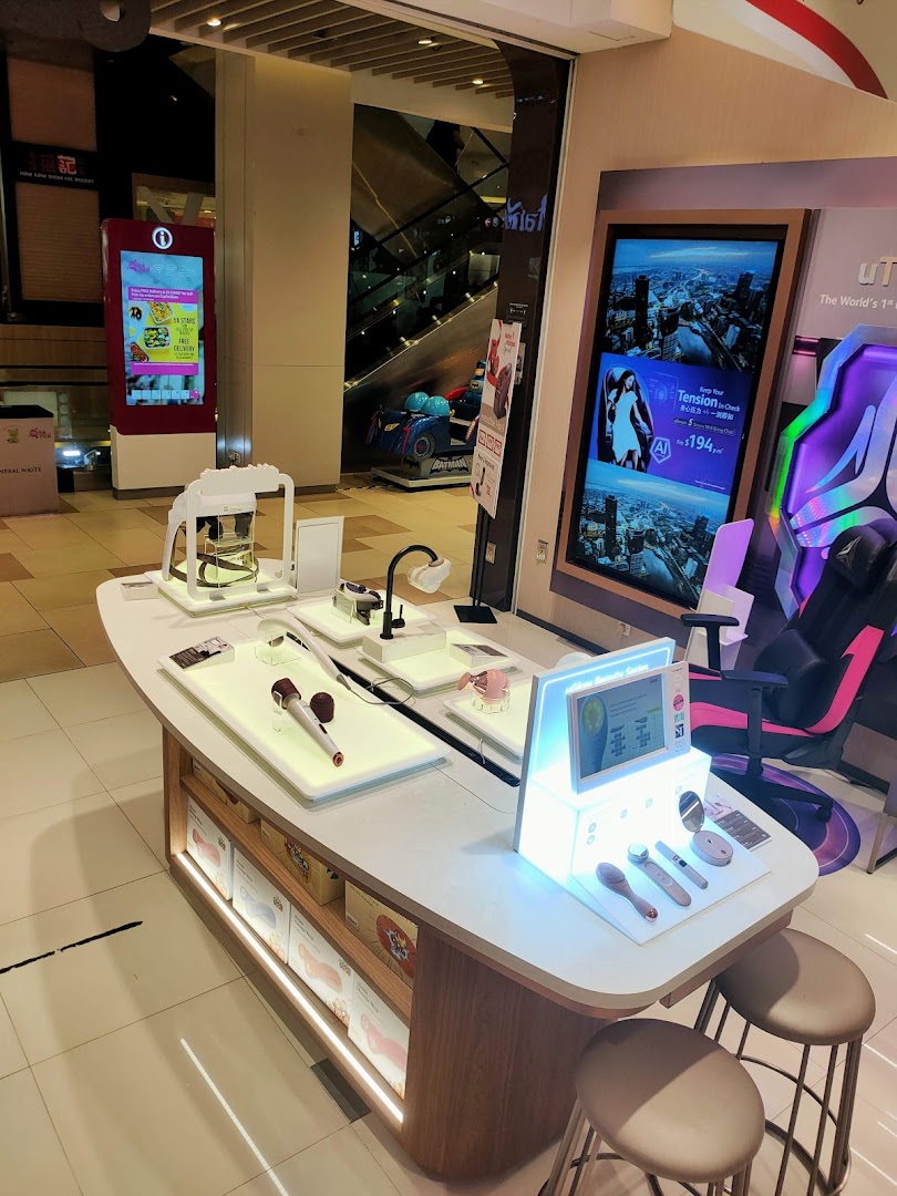 Interior view of a shop display with health products and digital screens.
